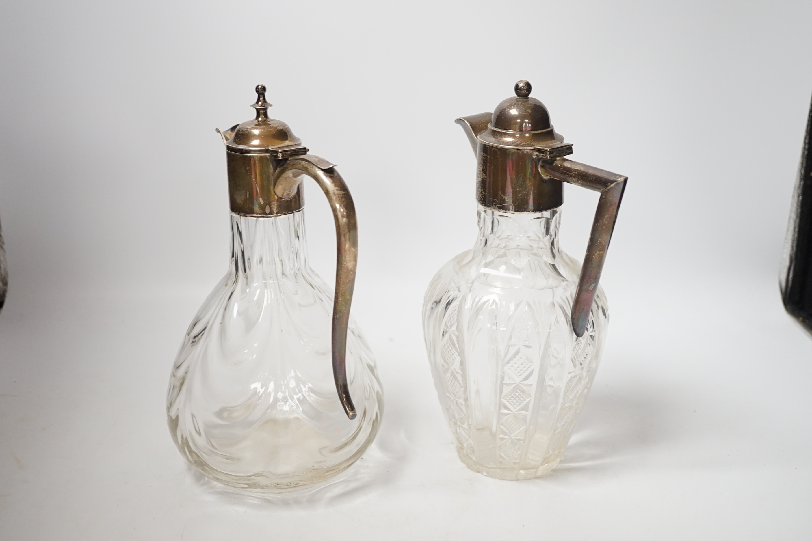 Two early 20th century silver mounted glass claret jugs, William Henry Leather, Birmingham, 1901 and William Aitken, Chester, 1901, tallest 24.2cm.